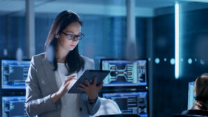 woman analyst data center tablet controls