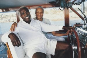 senior couple boat yacht retire retirement fishing wealth rich