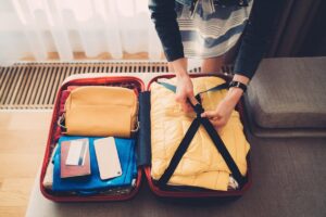 woman packing suitcase with credit card on top c1wnEKU
