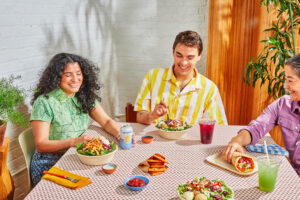 cava lifestyle picture showing three diners at a restaurant