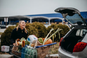 21 11 18 a person with a full shopping cart in front of an open car trunk gettyimages 1311819134