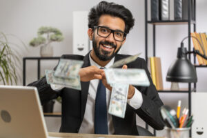 a businessman throws hundred dollar bills