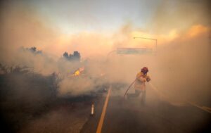 firefighter w hose in heavy smoke 1