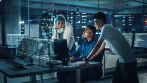 team of software engineers looking at a computer