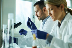 two scientists work at lab bench