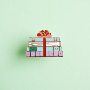 Enamel pin of a stack of books e1564694187633