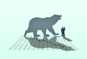 bear silhouette against a stock market downturn chart