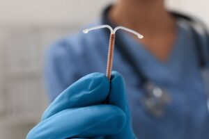 doctor holds long term birth control intrauterine device iud