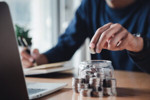 gettyimages saving coins in a jar writing in a journal