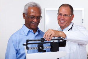 patient being weighed by a medical professional