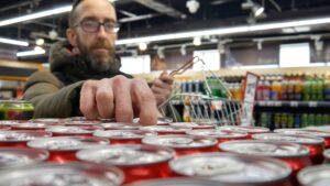 person buying a beverage in a store