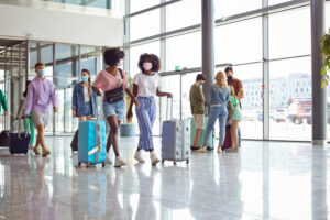 two travelers moving through an airport corridor