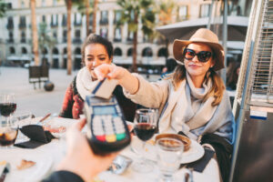 woman card payment restaurant getty 2022