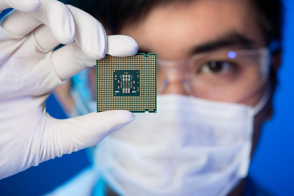 person holding a microchip