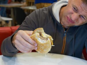 upset person holding a hamburger