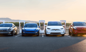 4 teslas in a line at a charging station
