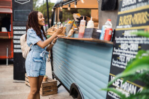 a person paying with a credit card at an outdoor stall