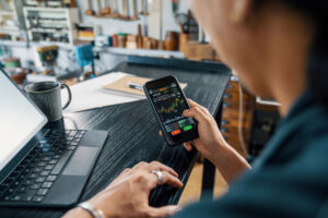 a person using a mobile device to buy a stock