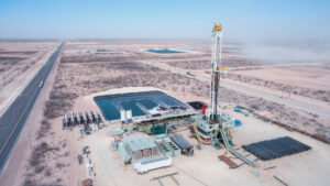 an oil and gas fracking rig and associated infrastructure in a desert setting