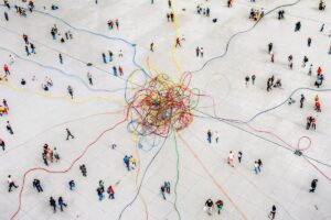 colorful threads tangled amongst crowd of people