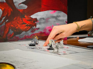 dungeons and dragons game in progress with a red dragon in the background