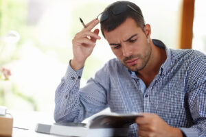 investor looks at book with consternation