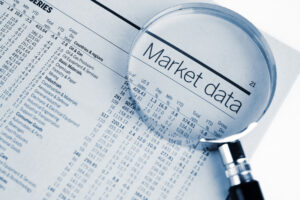 magnifiying glass financial newspaper market data stocks economy getty