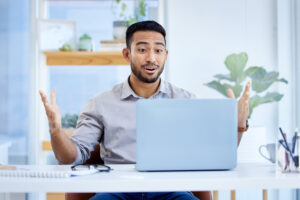person pleasantly surprised with laptop