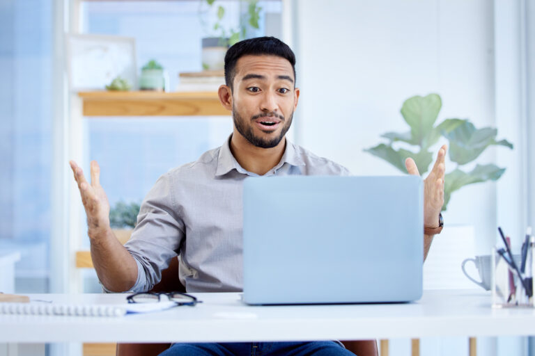 person pleasantly surprised with laptop