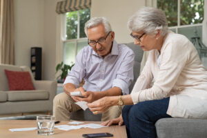 retired couple looking at financial paperwork