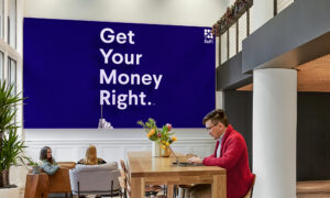 sofi office shot with sofi branding poster in background