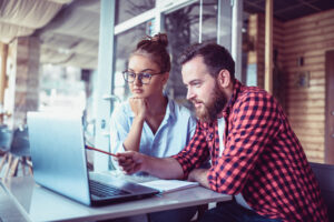 two investors consider a laptop